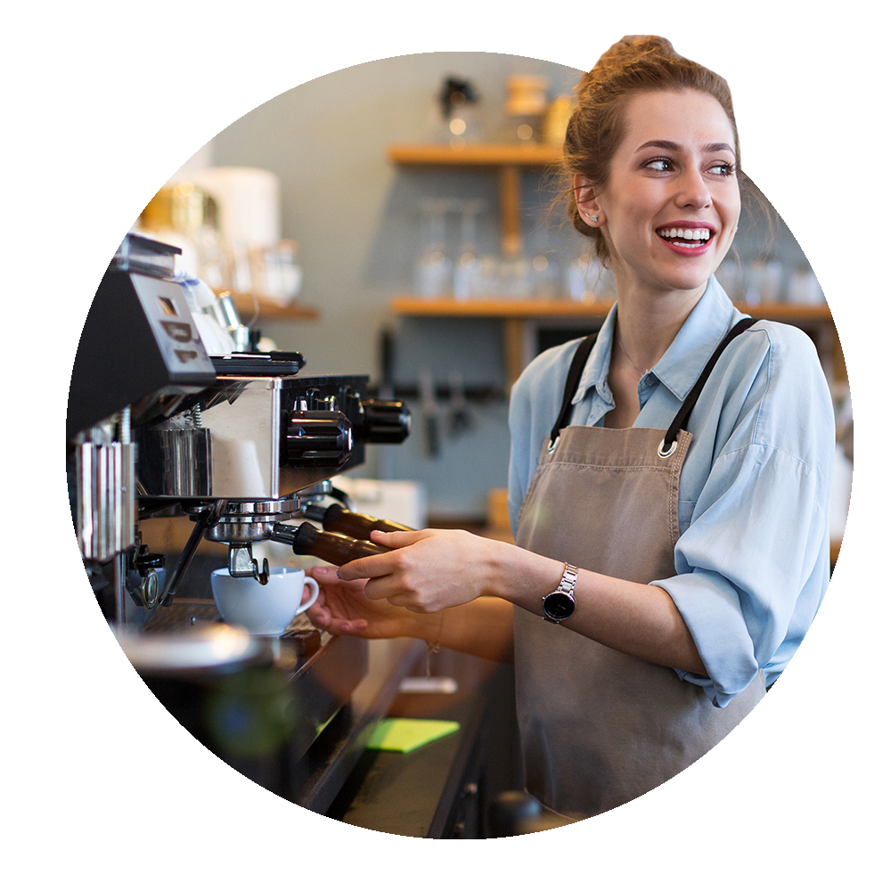 Circular image of newly hired barista making coffee for a customer
