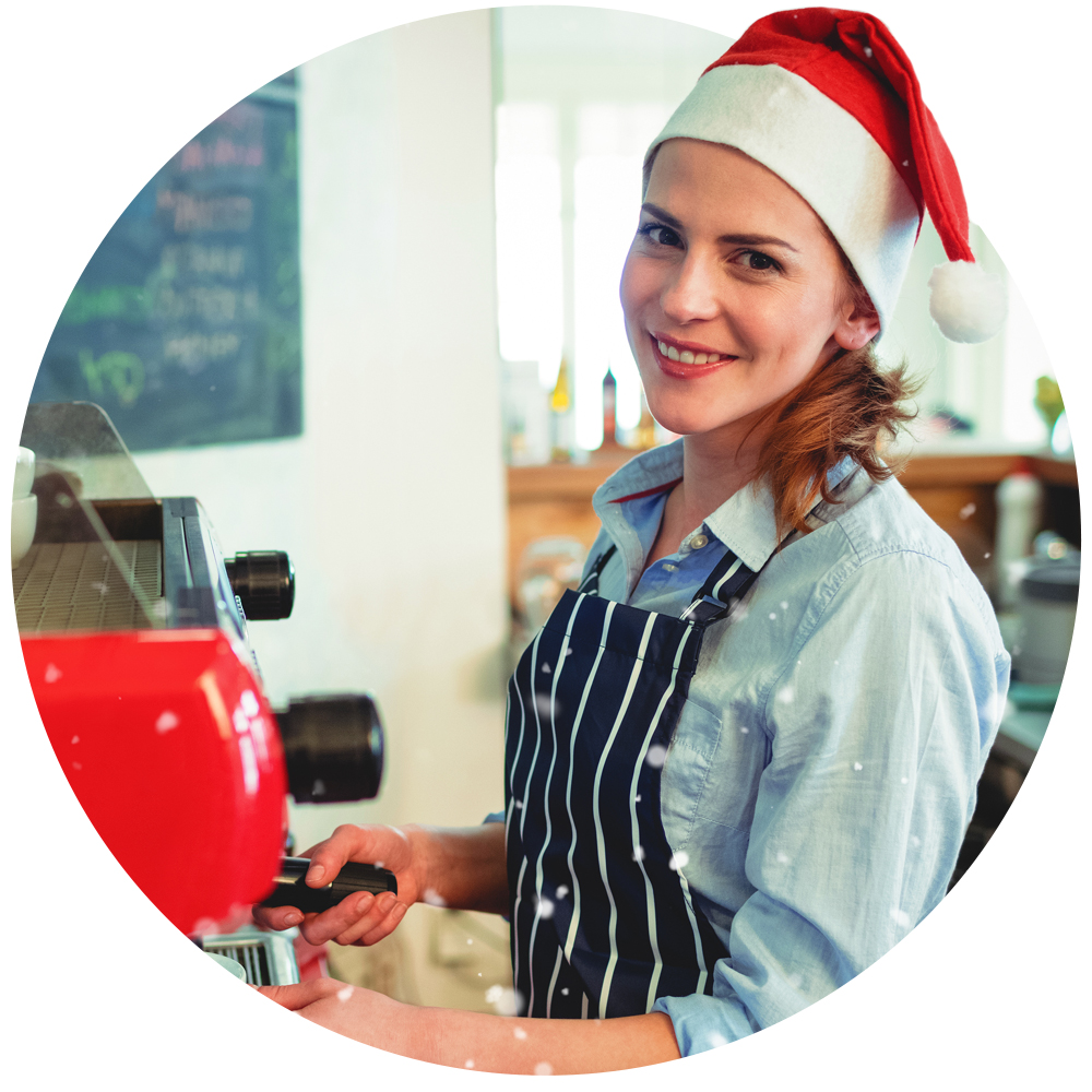 Circular image of a barista wearing a Christmas hat