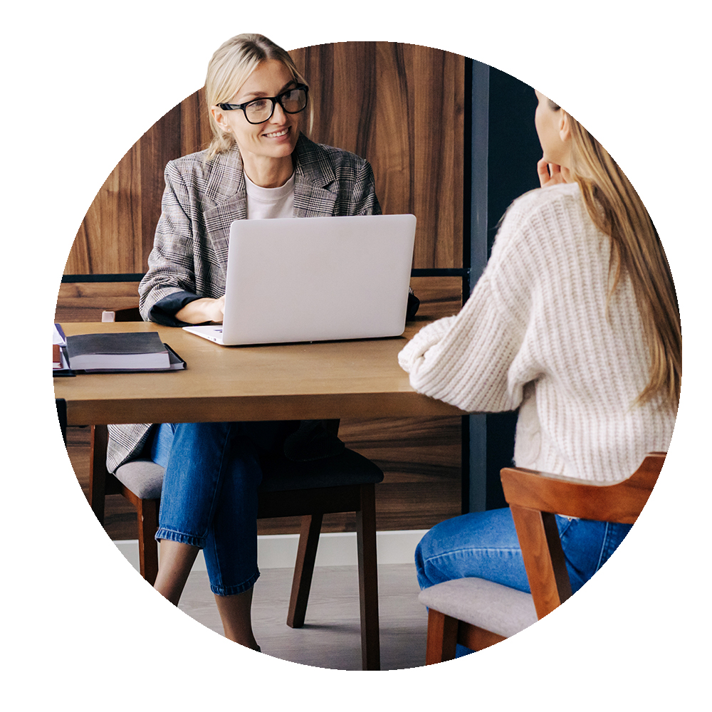 Circular image of manager interviewing potential candidate
