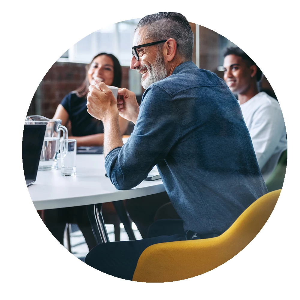 Circular image of colleagues in a meeting