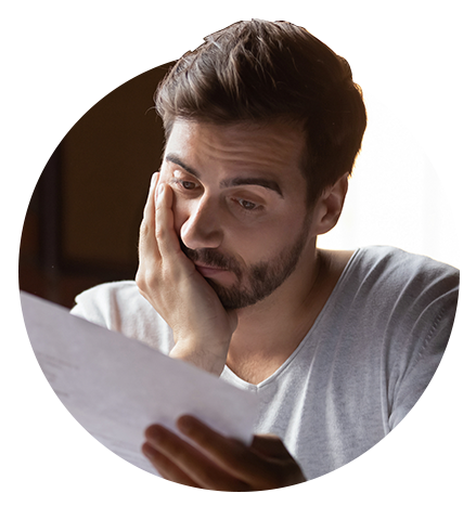 Business owner looking at paper documents concerned about looming recession - Circular image