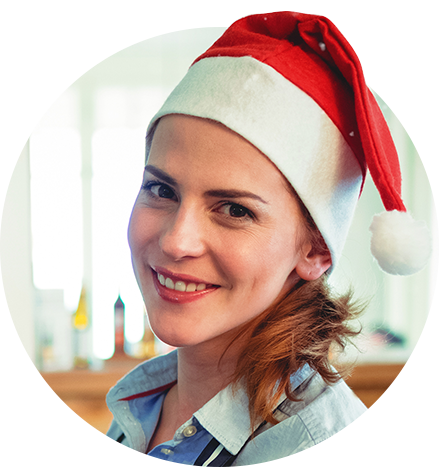 Seasonal worker smiling wearing a red Christmas hat