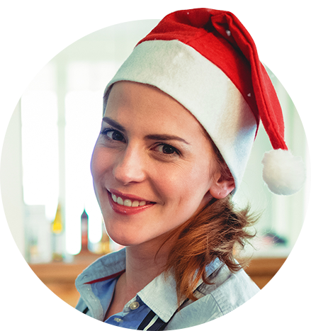 Seasonal worker smiling wearing a red Christmas hat