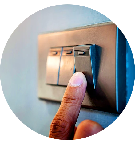 Employee switching light off to save energy in the workplace