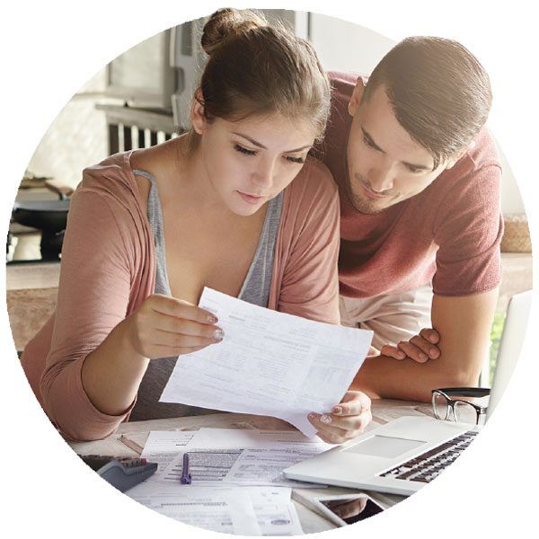 Couple looking at documents worried about the cost of living crisis