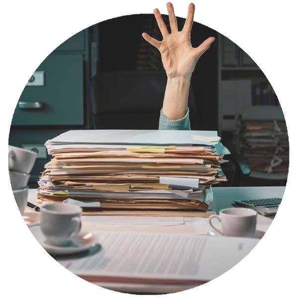 Circular image of office worker buried in paperwork